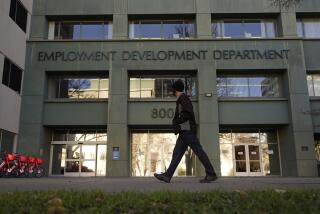 FILE - A person passes the office of the California Employment Development Department in Sacramento, Calif., Dec. 18, 2020 The department suspended about 345,000 disability claims associated with 27,000 doctors because of fraud concerns. On Thursday, Jan. 27, 2022, state officials said 98% of those 27,000 medical providers were likely fraudulent. (AP Photo/Rich Pedroncelli, File)