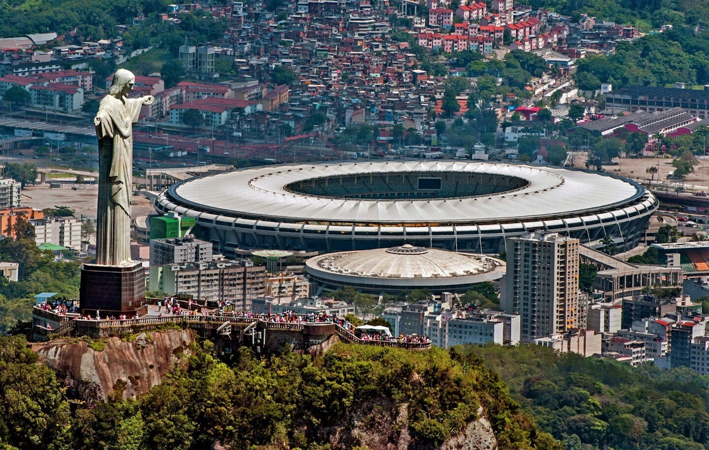 A statue of Christ the Redeemer atop Corcovado overlooks the Mário Filho (Maracanã) stadium in Rio de Janeiro. The Maracanã stadium will host both the Brazil 2014 FIFA World Cup and the 2016 Summer Olympics.