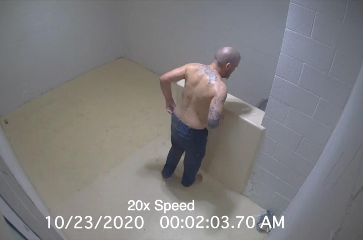 An image from jail security video shows a shirtless man in a cell.