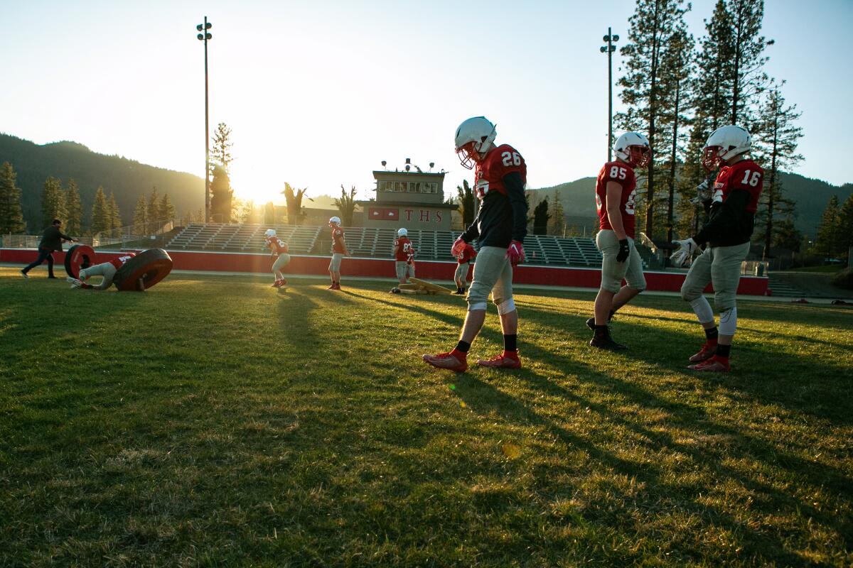 Trinity High School football players are on the field during practice