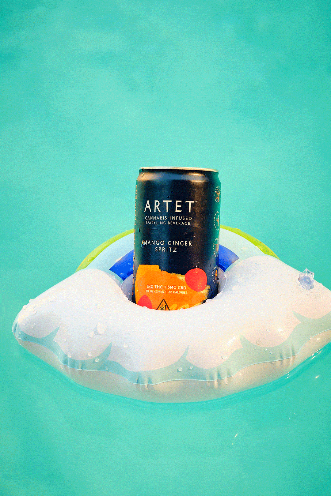A beverage can nestled in a cloud-shaped pool float.