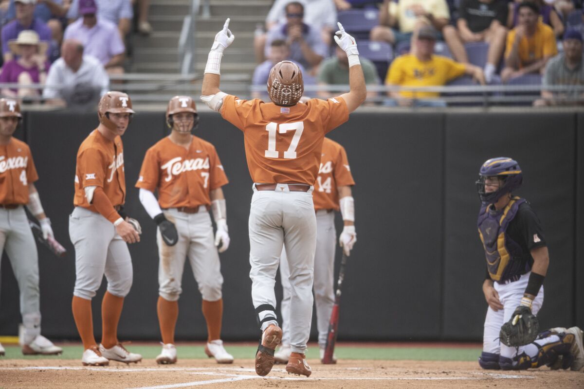 Texas' Ivan Melendez gestures at home plate after hitting a three-run home run during the first inning of an NCAA college super regional baseball game against East Carolina on Sunday, June 12, 2022, in Greenville, N.C. (AP Photo/Matt Kelley)