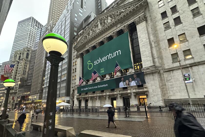 People walk past the New York Stock Exchange Wednesday, April 3, 2024 in New York. Healthcare business Solventum started trading at the NYSE on Wednesday. (AP Photo/Peter Morgan)