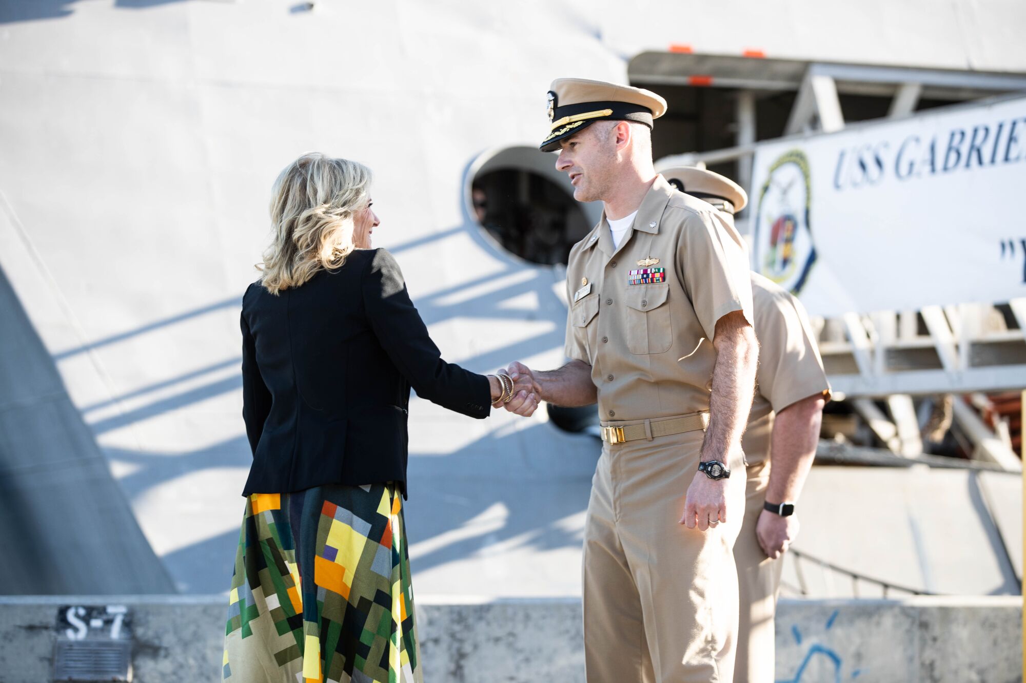 First Lady Dr. Jill Biden is greeted by Command Senior Chief Randy Griffeth before boarding the USS Gabrielle Giffords.