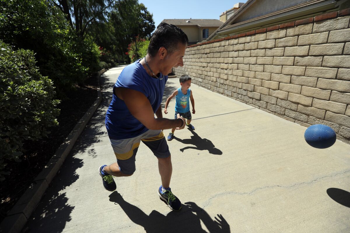 Jon Hatami and son Jon Jr. get in some play time outside.