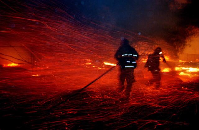 Fillmore firefighters Royce Davis, left, and Hector Garcia battle a wind driven brush fire near Ojai.