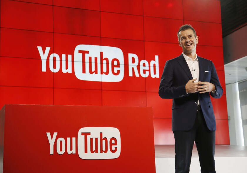 YouTube launched a subscription service last year called Red that charges $9.99 a month for an ad-free experience, access to Google Play music and a host of original content built around the company's stable of young stars like PewDiePie. Above, Robert Kyncl, YouTube chief business officer, at unveiling of the service.