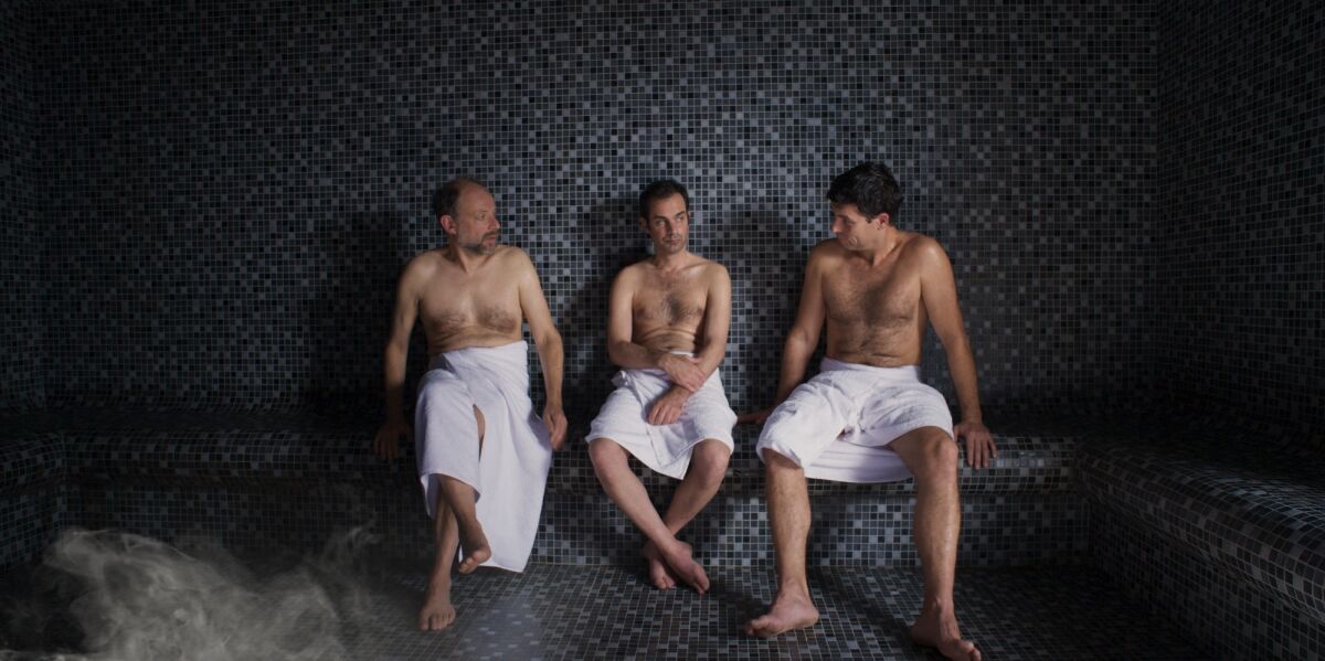 Three men clad in towels in a sauna in the movie “Bloody Oranges.”