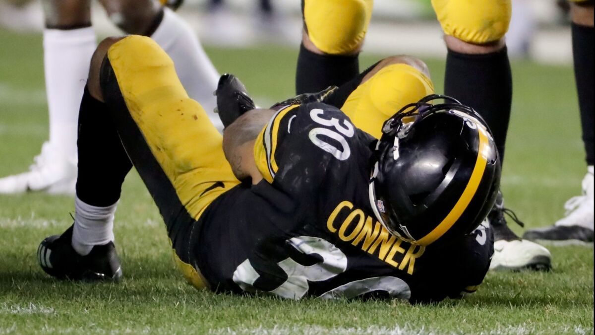 Steelers running back James Conner is injured after being tackled by Los Angeles Chargers defensive back Adrian Phillips.