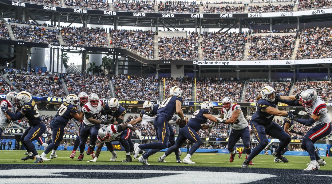Chargers quarterback Justin Herbert scrambles in the pocket near the goal line at SoFi Stadium.