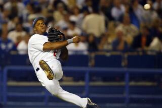 Dodgers third baseman Adrian Beltre throws out Brewers' Gary Bennett during a baseball game.