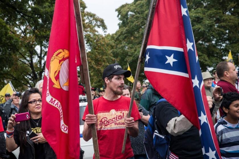 A man carries the Marine and confederate flags at a tea party/Republican rally in Washington. What's wrong with this picture?