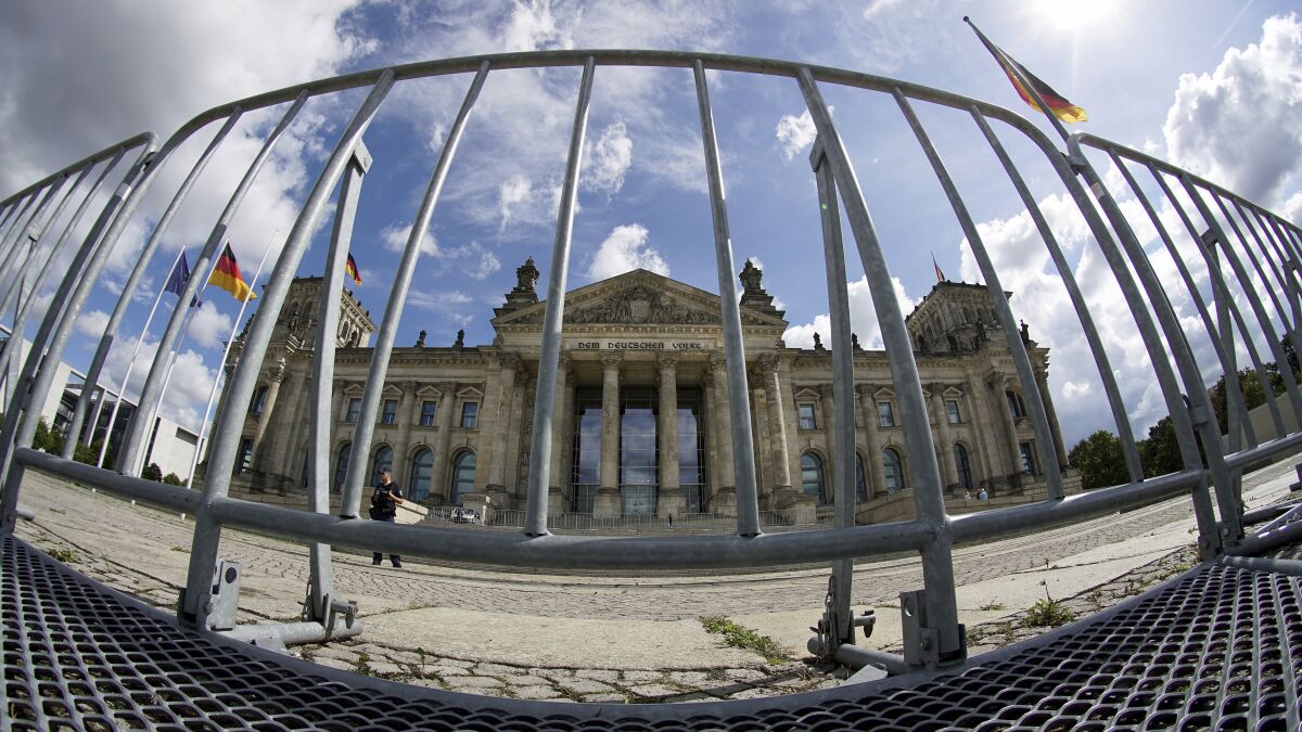 FILE - In this Monday, Aug. 31, 2020 file photo crowd control barriers are placed in front of the Reichstag building, home of the German federal parliament (Bundestag), in Berlin, Germany. German security officials are considering banning protests this week outside the federal parliament by people opposed to coronavirus lockdown measures over fears a rally could turn violent. (AP Photo/Michael Sohn, file)
