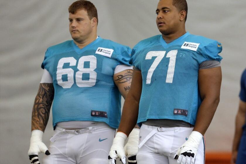 Miami Dolphins guard Richie Incognito (68) and tackle Jonathan Martin (71) during practice in July.