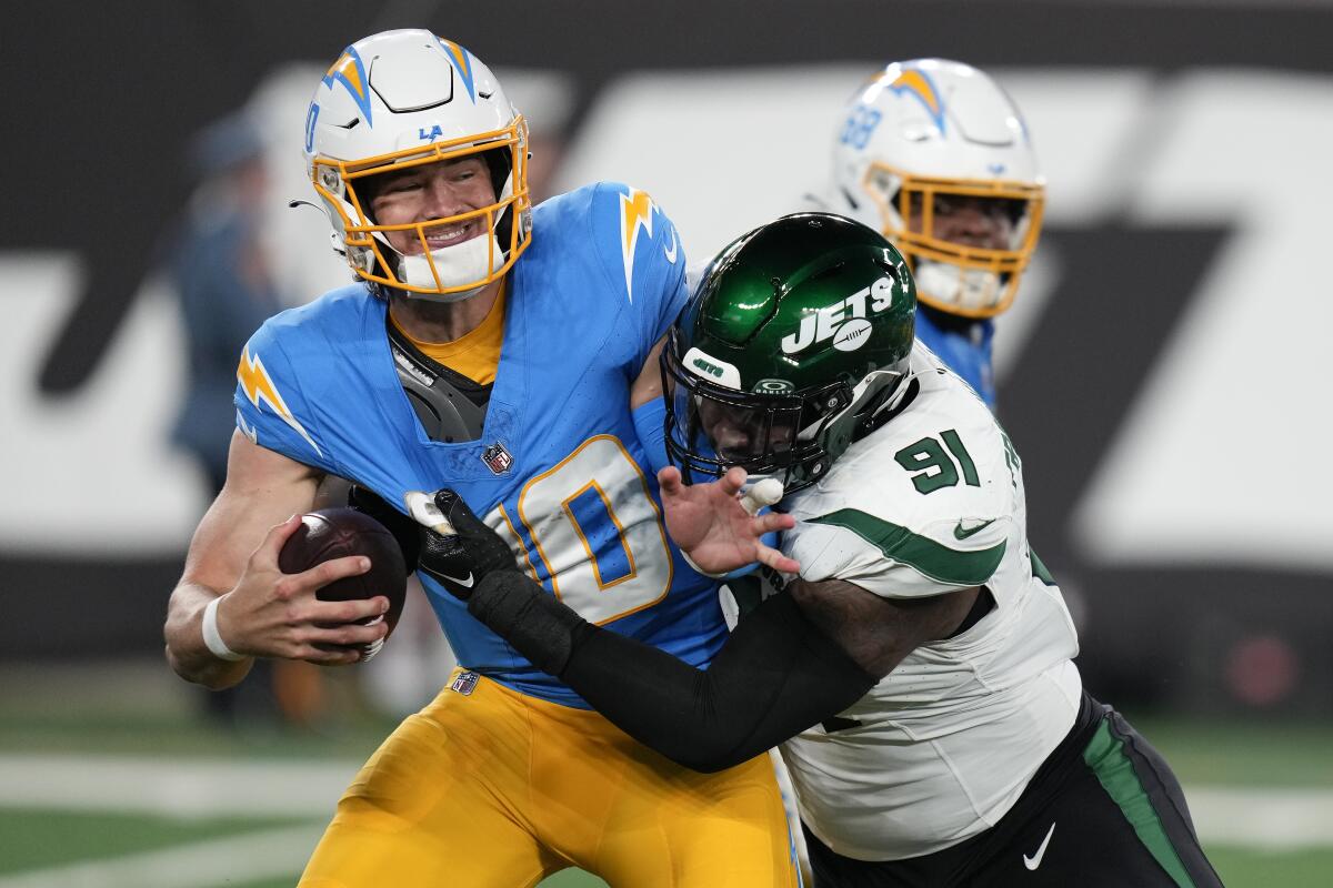 Chargers quarterback Justin Herbert is sacked by New York Jets defensive end John Franklin-Myers.