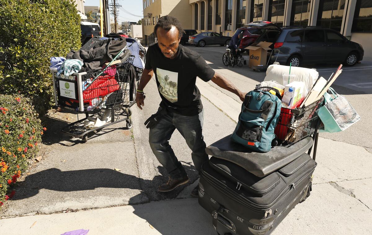 Jason Antoine Logan juggles 3 shopping carts filled with items but the things most important to him are carried in his backpack.