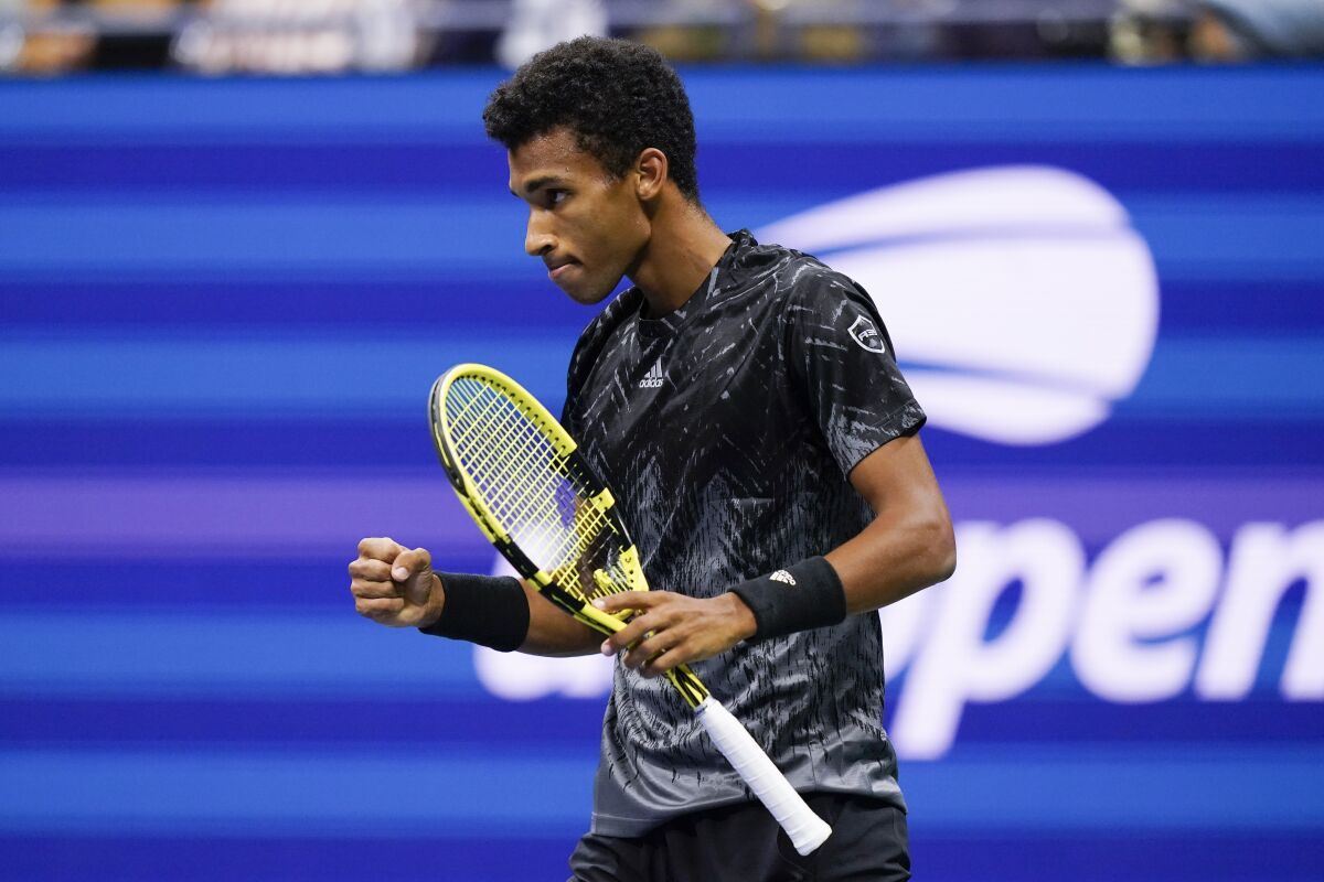 Felix Auger-Aliassime reacts to a point during a match against Carlos Alcaraz.