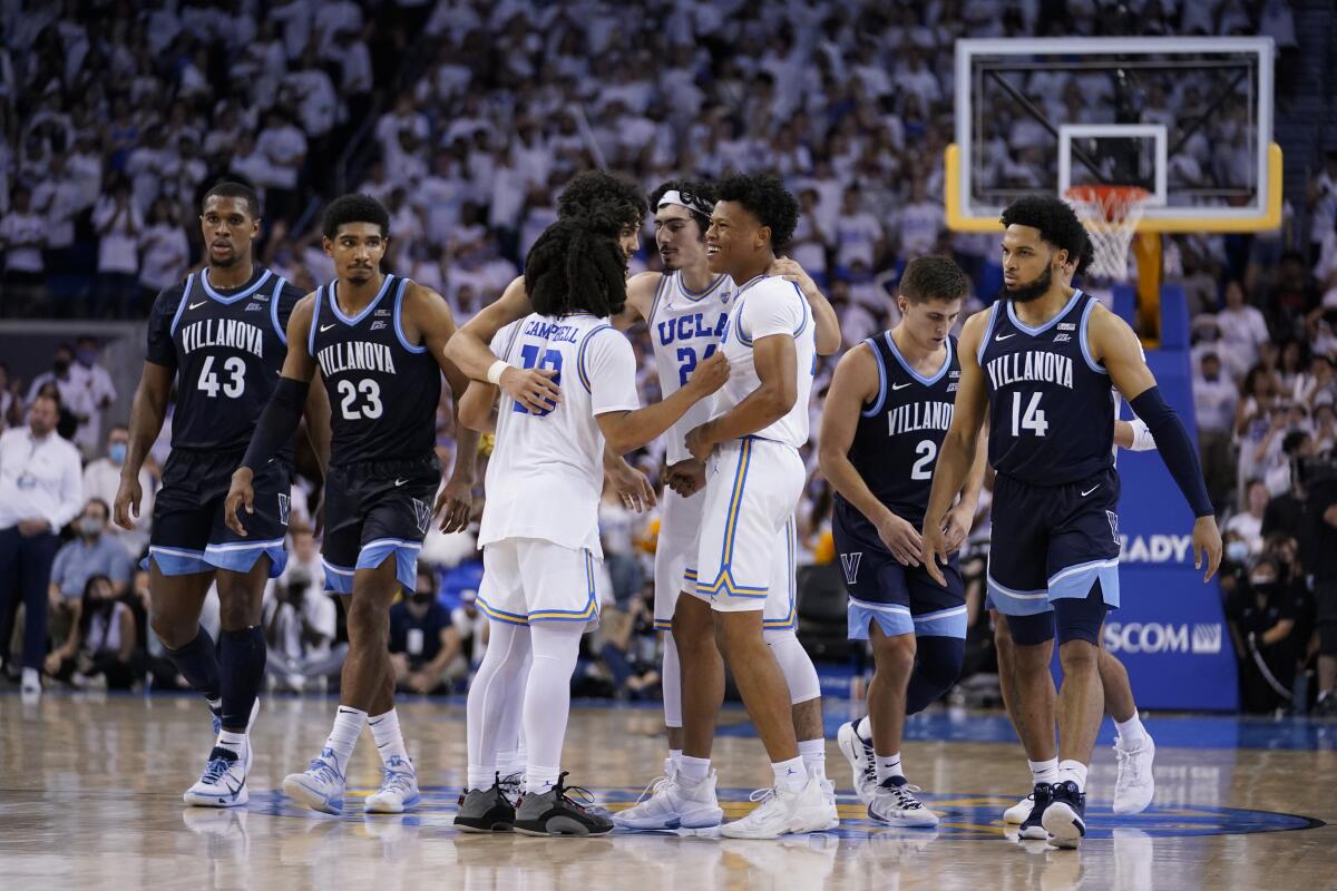 UCLA player huddle in the closing seconds of an overtime win over Villanova during an NCAA college basketball game Friday, Nov. 12, 2021, in Los Angeles. (AP Photo/Marcio Jose Sanchez)