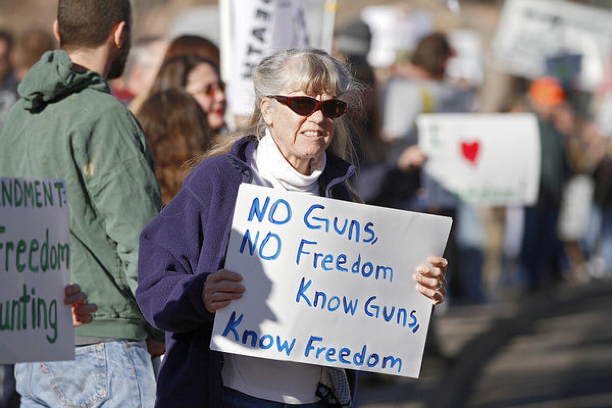 Protesters in Denver this week hold signs making a familiar, if absurd, argument: Guns guarantee freedom.
