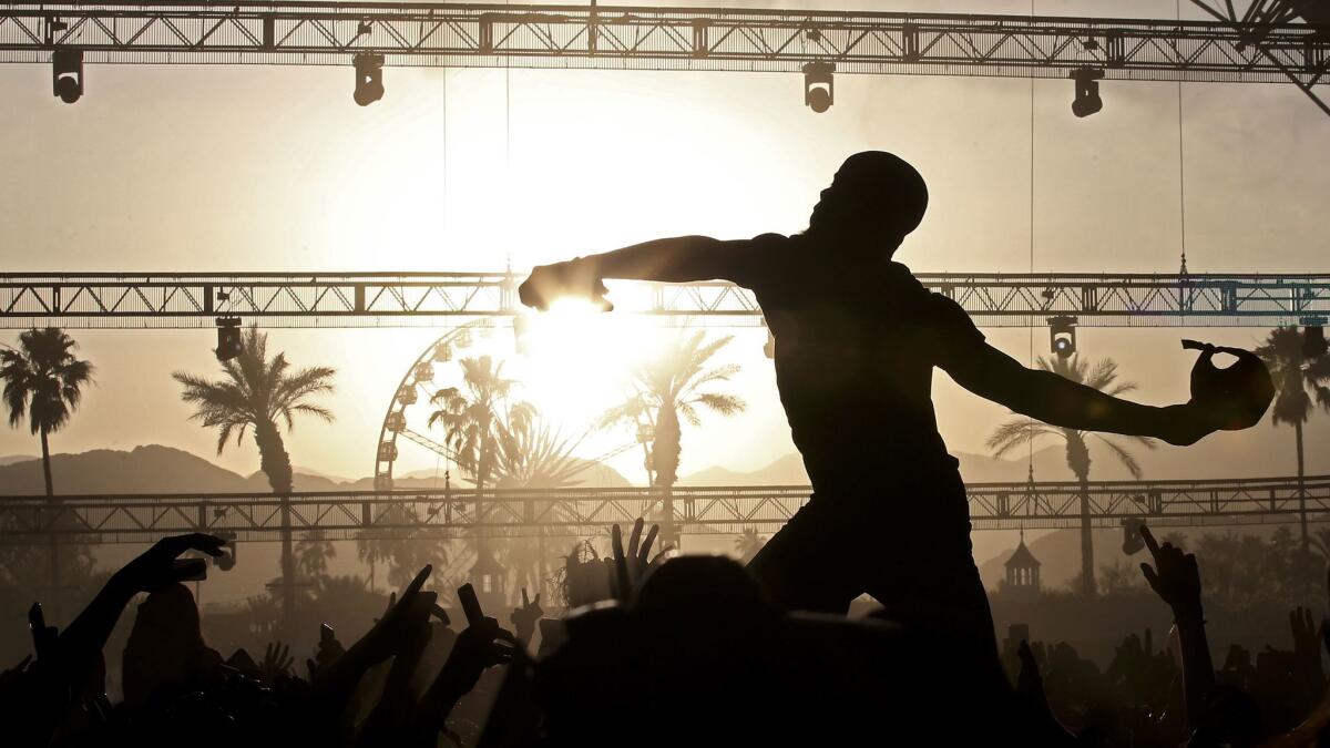 Fans hold up Canadian hip-hop artist Tory Lanez as he performs at the Coachella Music and Arts Festival in Indio on April 15. https://lat.ms/2pEtwwl