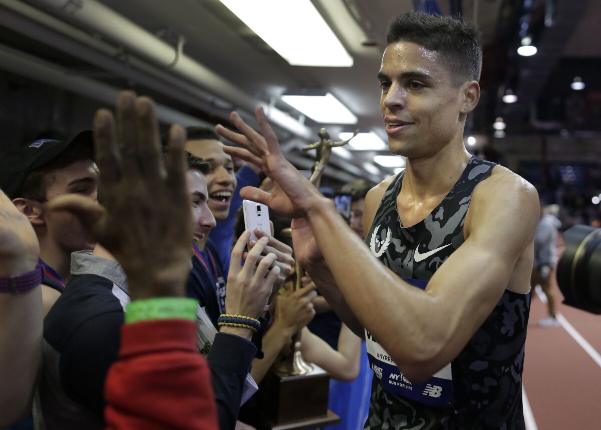 Matt Centrowitz, right, greets track and field fans after winning the Wanamaker Mile at the Millrose Games in 2016.