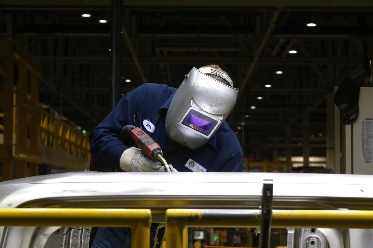 Ron Hudgins welds a 2015 Ford F-150 cab at the Dearborn Truck Plant in Dearborn, Mich., on Nov. 11.