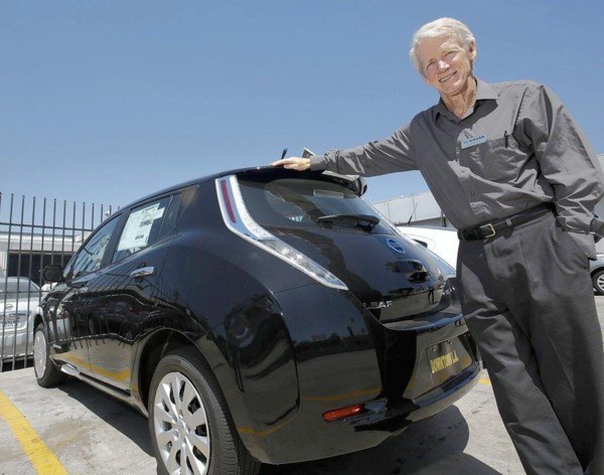Paul Scott is shown at the dealership where he sells Nissan Leafs, an electric-powered car. He got an invitation to a Democratic fundraiser in Santa Monica and wanted a chance to tell President Obama about the virtues of electric vehicles. But the DNC, insinuating that he was merely seeking media attention, rescinded his invitation and returned his large donation.