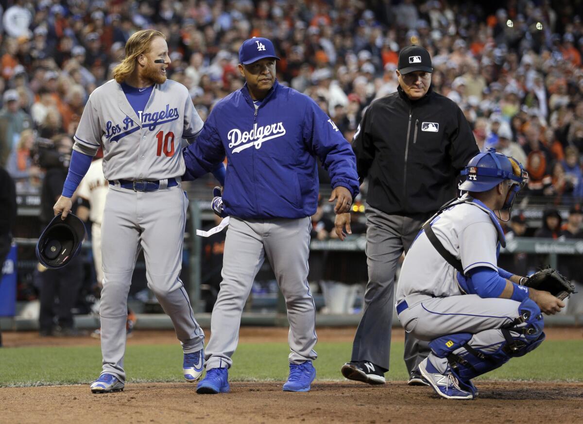 Dodgers Manager Dave Roberts separates Justin Turner (10) from home plate umpire John Hirschbeck after Turner was ejected in the eighth inning.