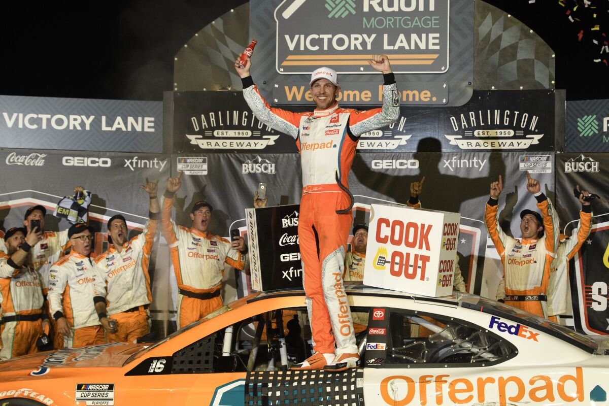 Denny Hamlin celebrates in victory lane after winning a NASCAR Cup Series auto race Sunday, Sept. 5, 2021, in Darlington, S.C. (AP Photo/John Amis)