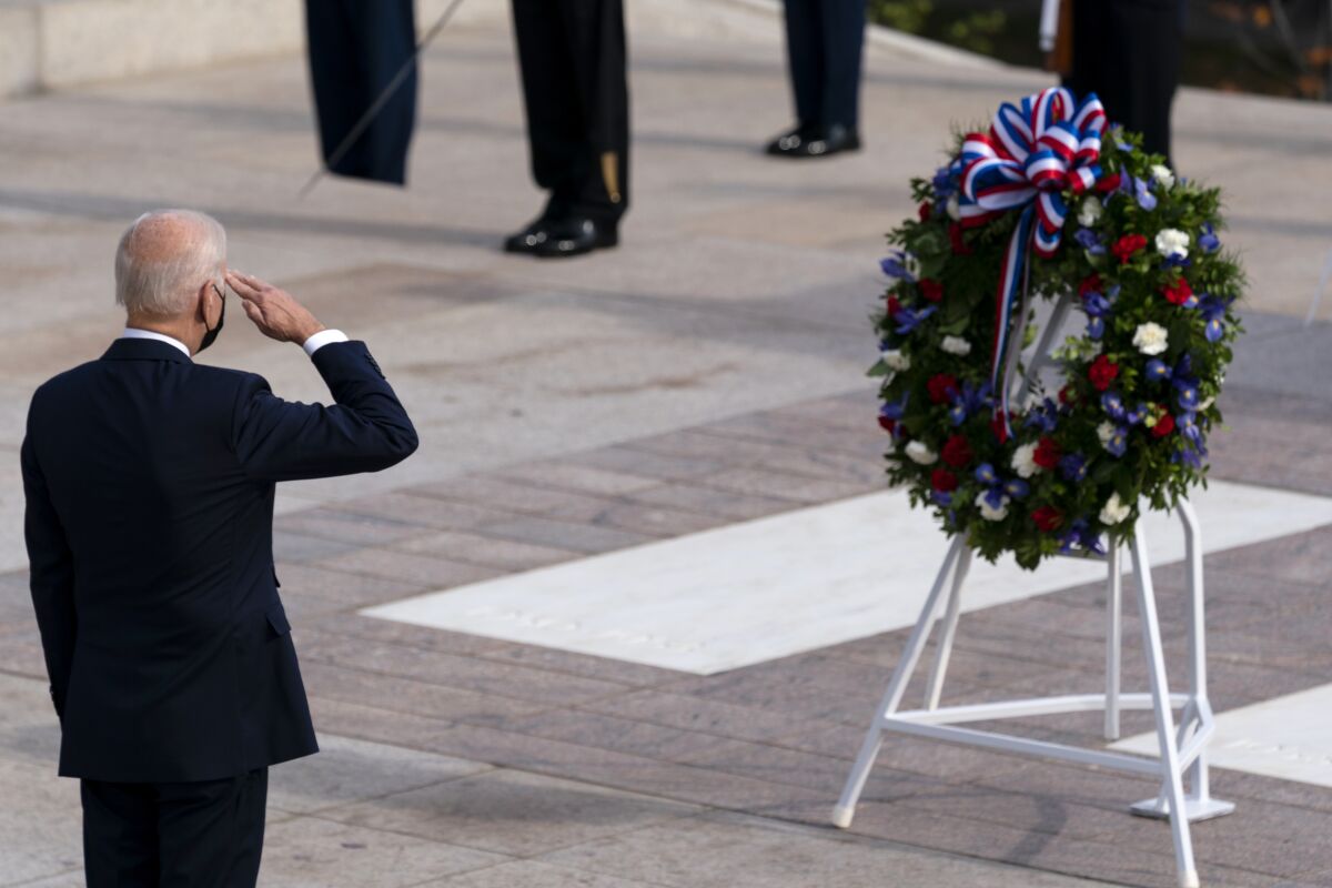 President Joe Biden salutes before placing a wreath during a centennial ceremony for the Tomb of the Unknown Soldier, in Arlington National Cemetery, on Veterans Day, Thursday, Nov. 11, 2021, in Arlington, Va. (AP Photo/Alex Brandon, Pool)