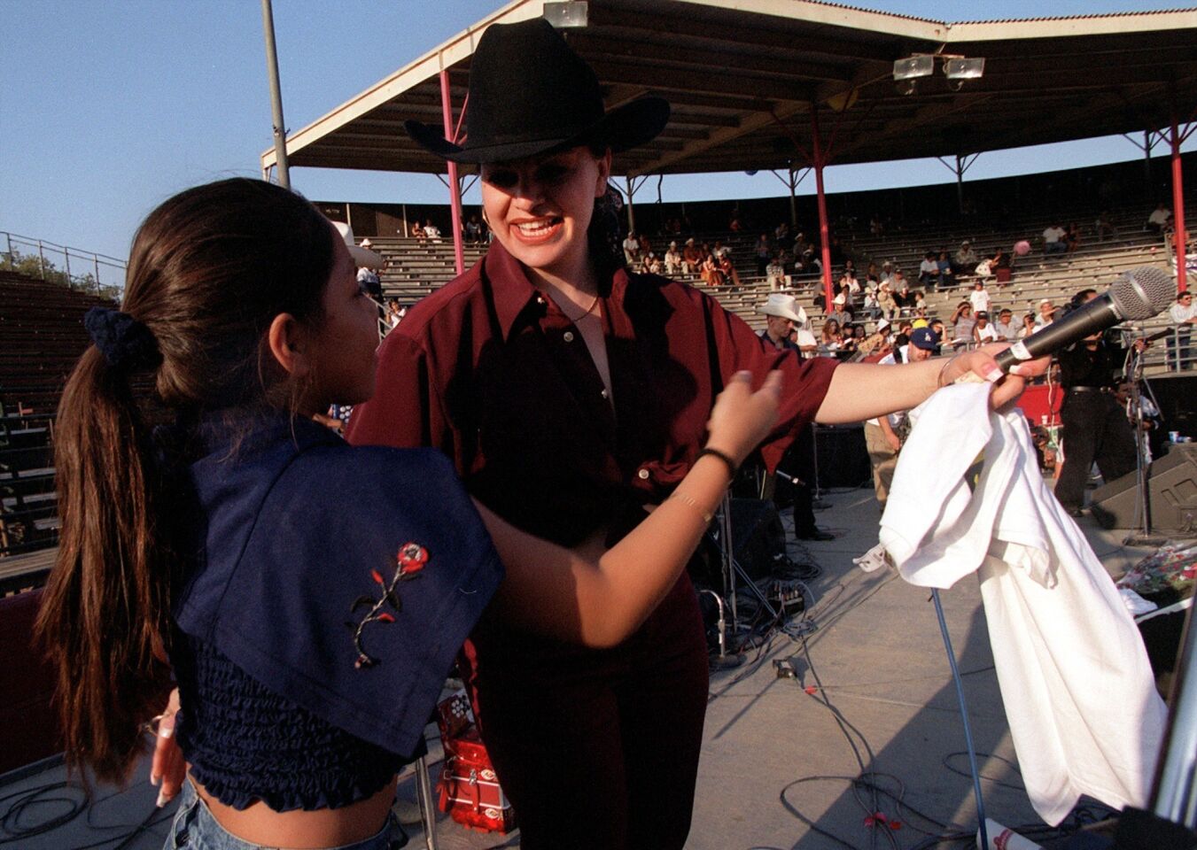 Jenni Rivera teases a fan with a promotional tee shirt who won it during her concert at the Pico Rivera Sports Arena.