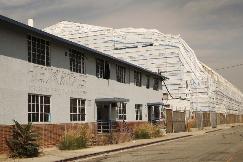 LOS ANGELES, CA - OCTOBER 06: Portions of the Exide Technologies, lead-acid battery recycling plant located in Vernon are wrapped in white plastic even as a press conference with state and local elected leaders was held at Resurrection Church in the Boyle Heights neighborhood of Los Angeles to express their opposition to Exide's proposed bankruptcy settlement, specifically in regard to the option for Exide to fully abandon the facility in Vernon and its responsibility to clean the environmental damage it caused. Resurrection Church on Tuesday, Oct. 6, 2020 in Los Angeles, CA. (Al Seib / Los Angeles Times