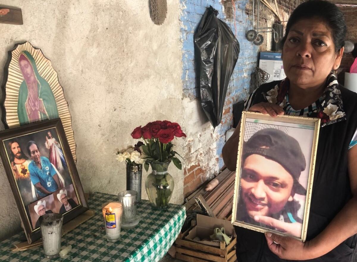 Natalia Acosta Medina holds a photo of her son, Marco Antonio Castillo Medina. 