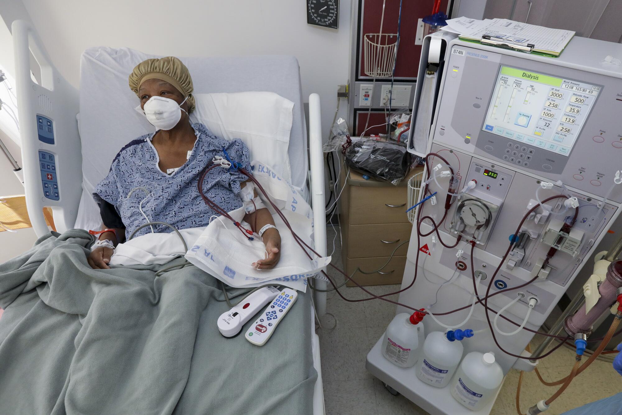 Janice Brown is hooked up to a dialysis machine in COVID-19 unit isolation room at Desert Valley Medical Group, Victorville.