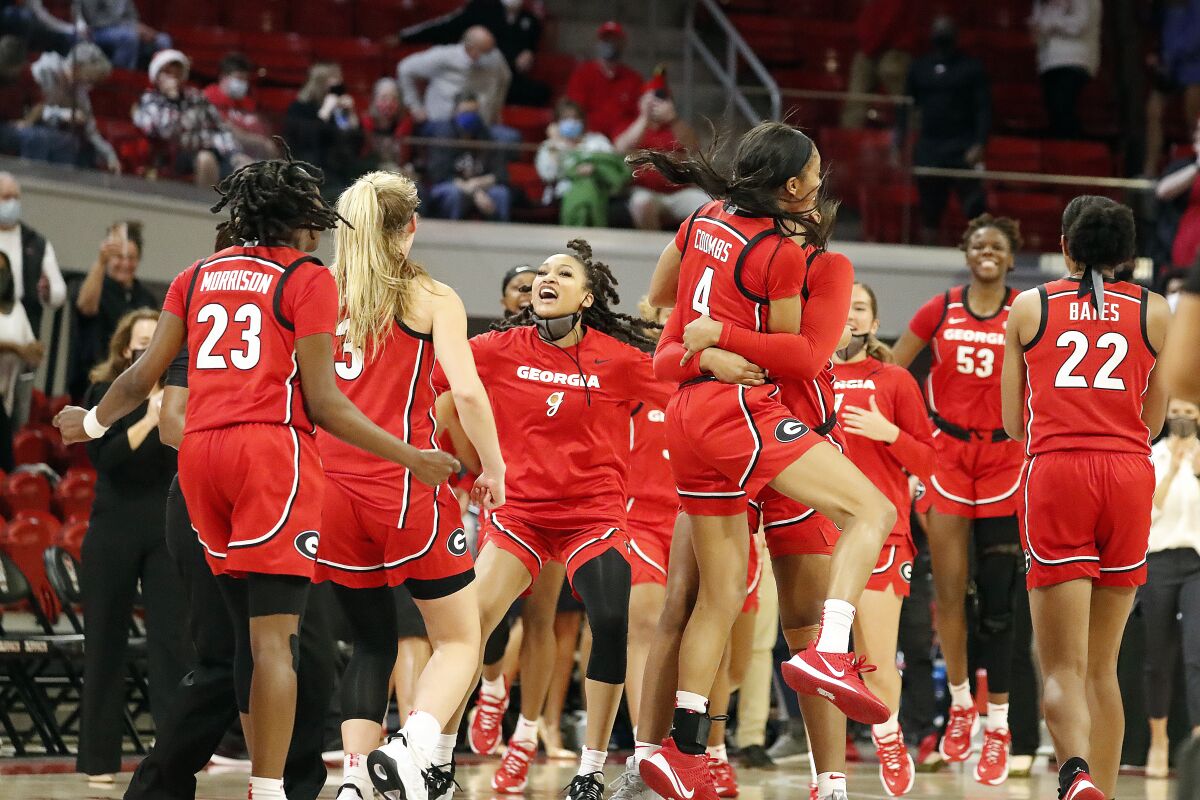 Georgia players celebrates their win over North Carolina State in an NCAA college basketball game, Thursday, Dec. 16, 2021, in Raleigh, N.C. (AP Photo/Karl B. DeBlaker)