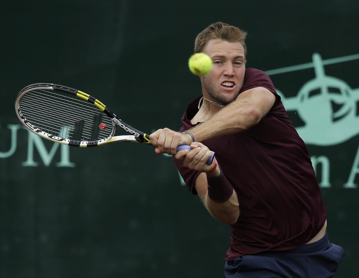 Jack Sock returns a shot against John Isner in the semifinals of the U.S. Men's Clay Court Championship on Saturday.