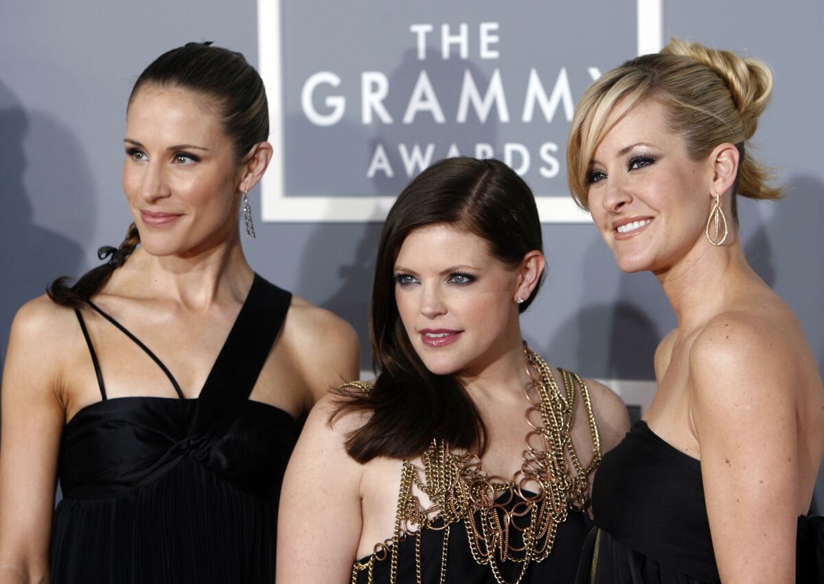 FILE - In this Feb. 11, 2007 file photo, the Dixie Chicks, Emily Robison, left, Natalie Maines, center, and Martie Maguire arrive for the 49th Annual Grammy Awards in Los Angeles. The Grammy-winning country group, who recently changed their name to The Chicks, have a new album "Gaslighter" out July 17, 2020. (AP Photo/Matt Sayles, File)