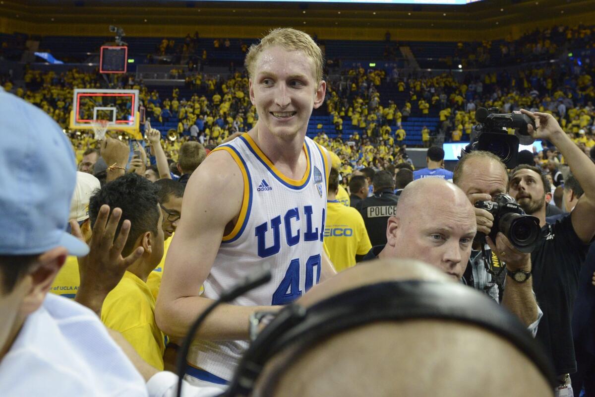 UCLA's Thomas Welsh, center, celebrates with fans after the Bruins' win over Kentucky on Thursday.