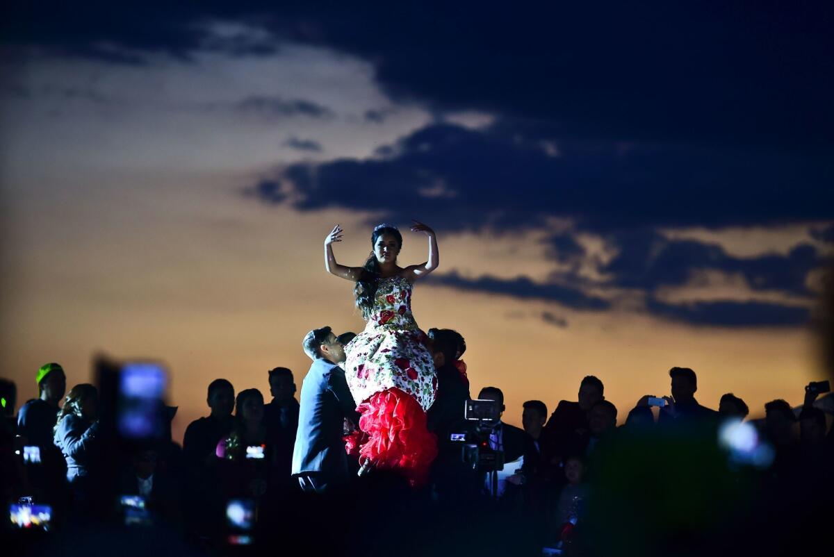 Rubi Ibarra (C)dances during her 15th birthday celebrations in Villa Guadalupe, San Luis Potosi State, on December 26, 2016. Rubi, a small-town Mexican teen, welcomed thousands of guests for her 15th birthday party after her parents' video invitation to the milestone event went viral online.