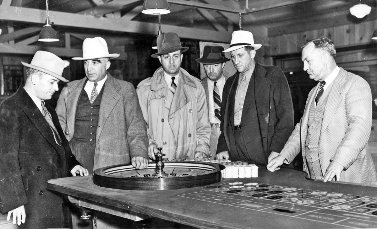 Tony Cornero, left, chats with law enforcement officials aboard the S.S. Rex gambling ship on May 14, 1938.