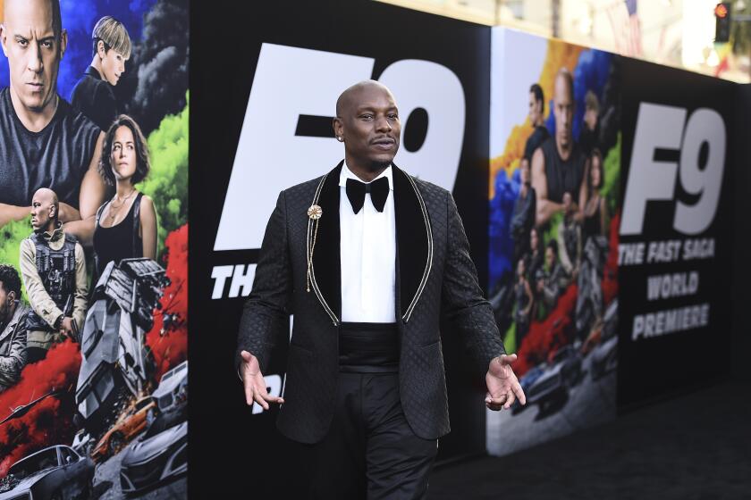 A man arrives at a movie premiere wearing a black tuxedo