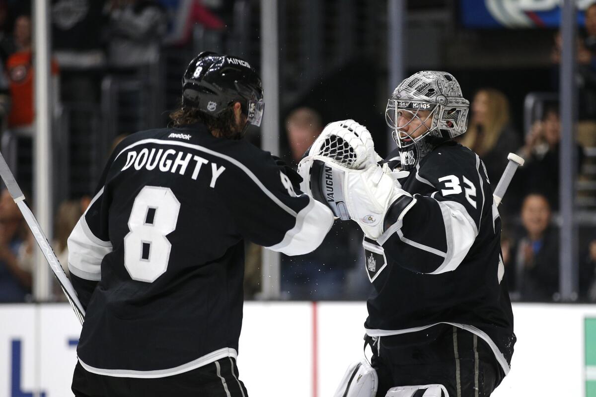 Kings goalie Jonathan Quick (32) and Drew Doughty (8) celebrate their team's 2-1 win against the Philadelphia Flyers on Jan. 2.