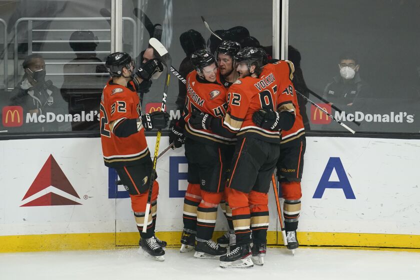 Anaheim Ducks players celebrate after defenseman Cam Fowler (4) scored a goal during the third period of an NHL hockey game against the Los Angeles Kings Wednesday, April 28, 2021, in Los Angeles. (AP Photo/Ashley Landis)