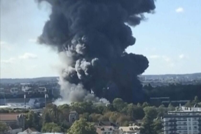 In this image taken from video, smoke rises from a warehouse blaze at a produce market in Paris' southern suburbs, Sunday, Sept. 25, 2022. A billowing column of dark smoke towered over Paris on Sunday from a warehouse blaze at a massive produce market that supplies the French capital and surrounding region with much of its fresh food and bills itself as the largest of its kind in the world. (Martin Rouger, Sonia Hamdi via AP)