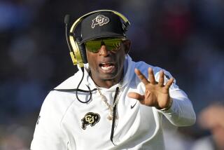 Colorado head coach Deion Sanders shouts at an official during the first half.
