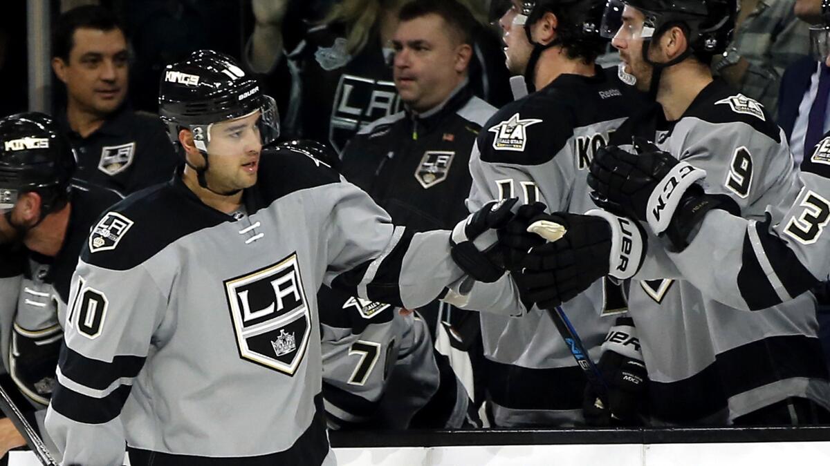 Kings right wing Devin Setoguchi (10) is congratulated by teammates after scoring against the Calgary Flames during the first period Saturday night.