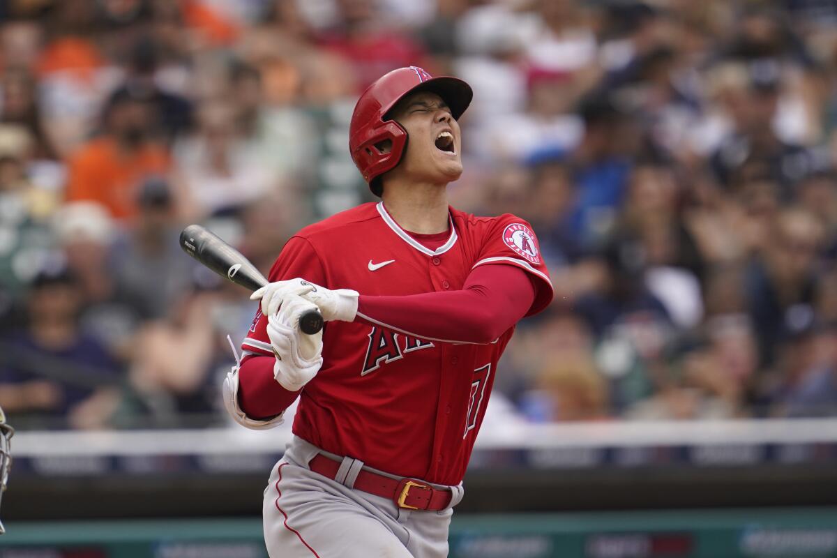 Angels star Shohei Ohtani winces and opens his mouth after fouling a ball off his foot.