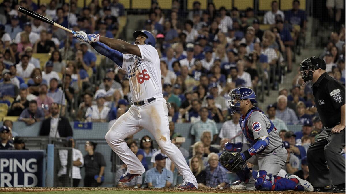 Yasiel Puig strains to foul off a pitch against Cubs reliver Carl Edwards Jr.