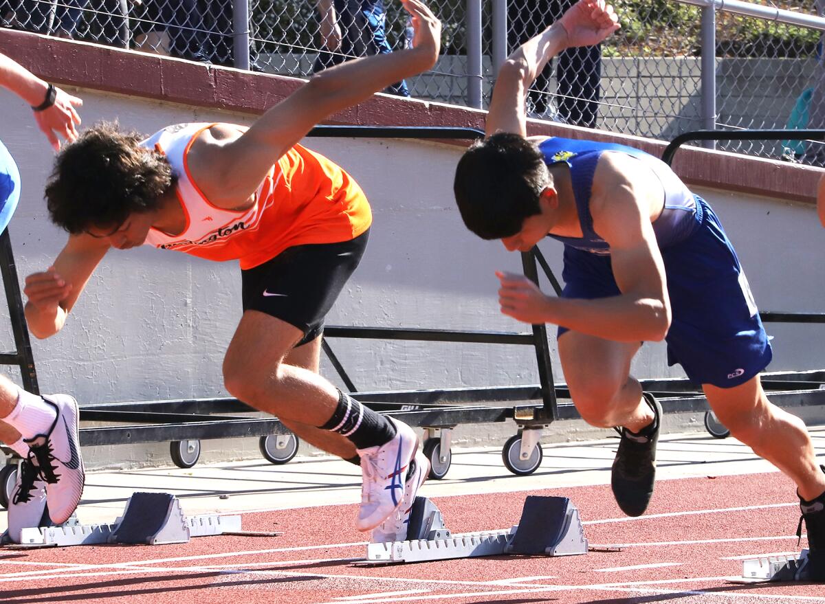Huntington Beach's Kieren Beckman, left, and Fountain Valley's Jonathan Yu compete in the 110-meter high hurdles.