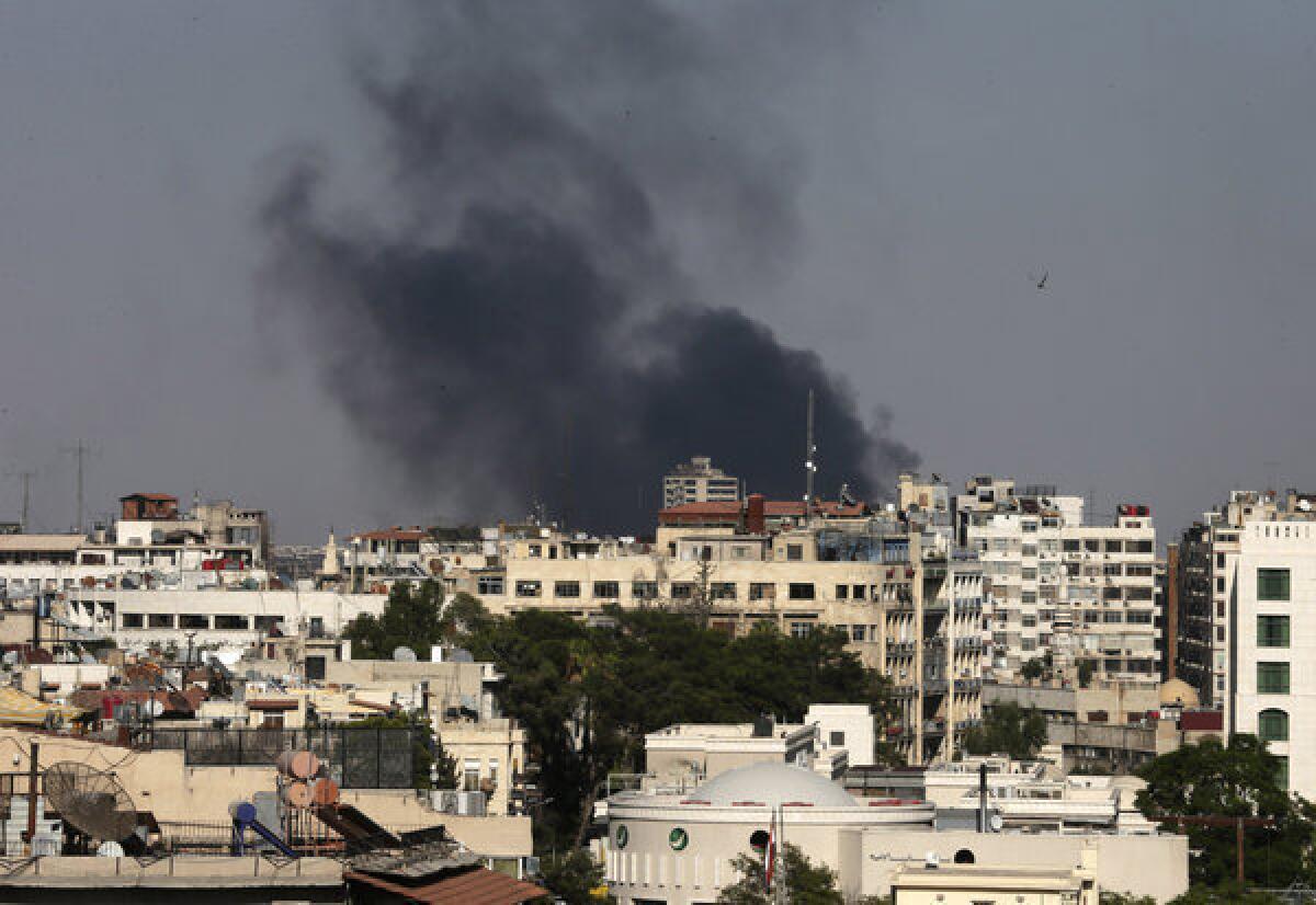 Black columns of smoke rise from heavy shelling in the Jobar neighborhood east of Damascus, Syria, on Sunday. Syria reached an agreement with the United Nations to allow a U.N. team of experts to visit such areas, sites of alleged chemical weapons attacks last week.